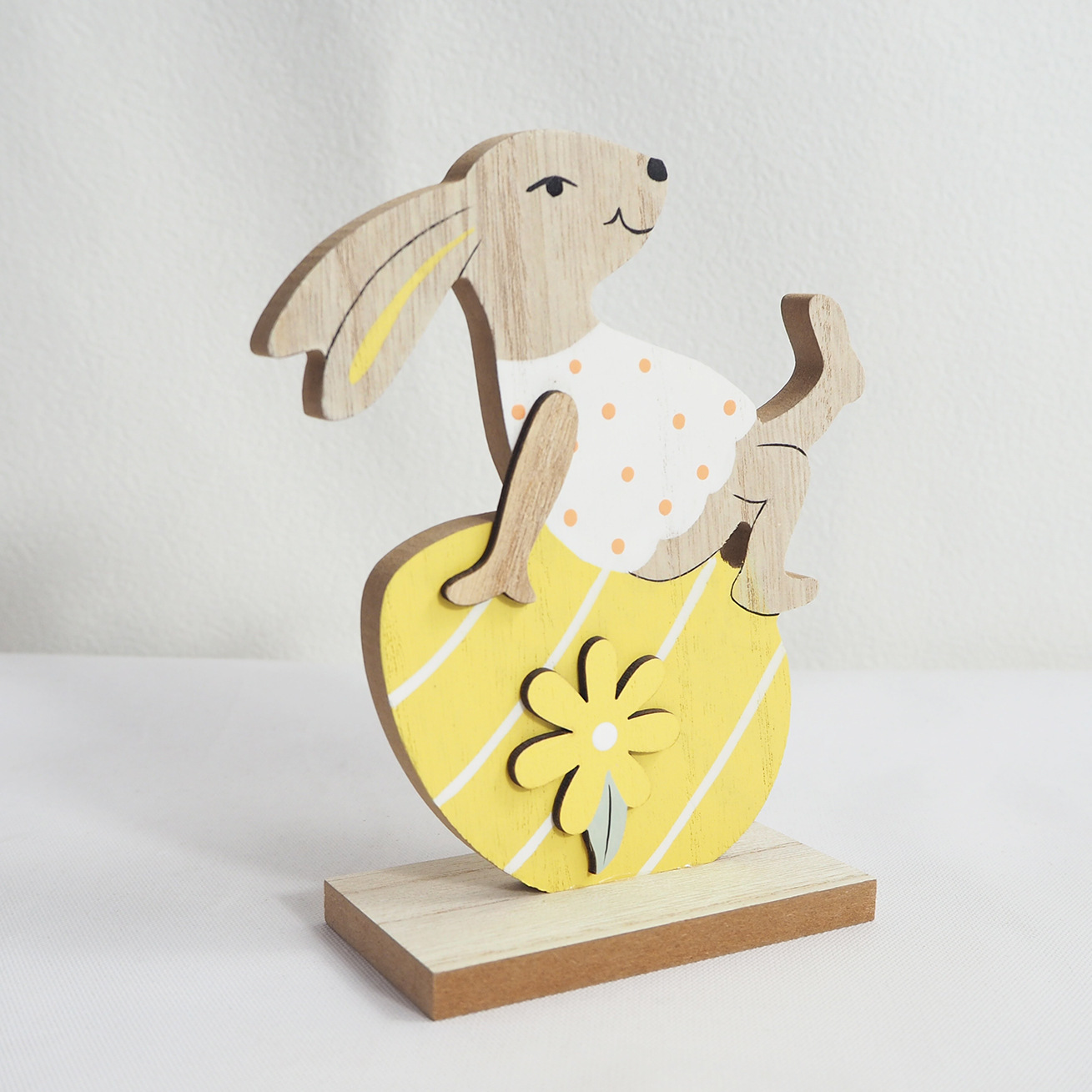 A cute spotted rabbit sitting on a yellow carrot. It is an Easter decoration at home and also also be given as a gift to family and friends,Cute Bunny Easter Crafts Ornaments