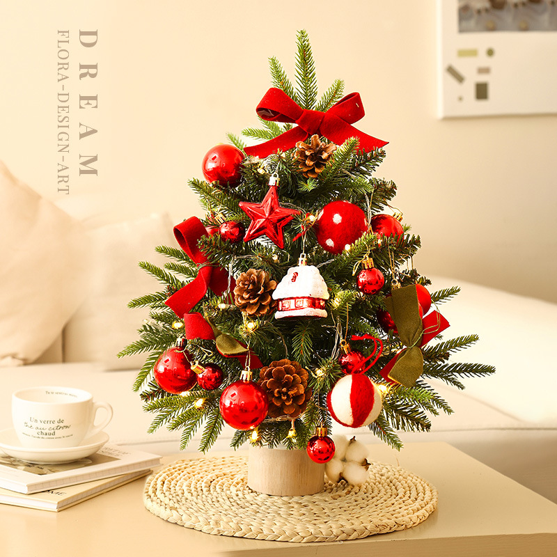 The small Christmas tree is decorated with red balls, pine cones, butterfly knots, and five-pointed stars.