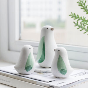 Ceramic stabilizing ornaments. Three white and green little penguins