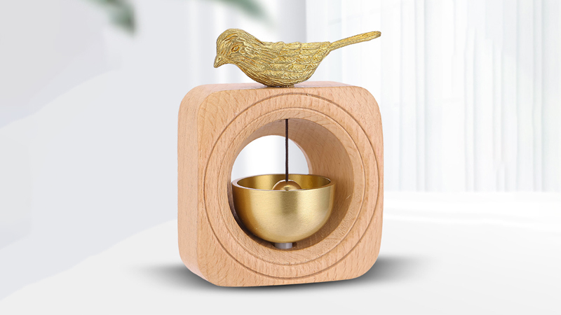 The brass magnetic door bell with a bird standing on a wooden frame can be used as a gift, a car ornament, or a home ornaments