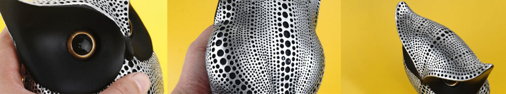 Close-up details of silver and black owl decorations for the home, featuring a dotted texture and smooth metallic finish, ideal for tabletop or shelf display.