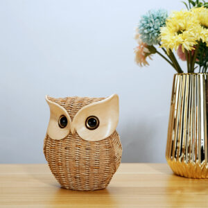 The resin owl figurine is woven from imitation rattan and is ideal for rustic home decor and unique owl craft collections.